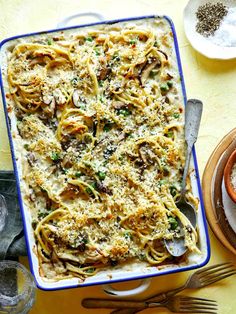 a casserole dish with pasta, mushrooms and parmesan cheese