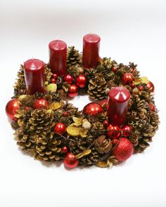 a christmas wreath with red candles and ornaments