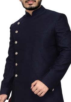 A Long and royal indian ethnic indian wear sherwani especially designed for men in order to make an occasion very especial. It is elegantly made with hands to bring about a feel about India. Look your best on your special day while you carry your sharp attitude with this indowestern sherwani paired with a churidar. Colored in oxford blue color and black embellished with woven work. Available with gold color cotton silk churidar. Slip on to some matching mojari and a matching safa to complete the Bollywood Style Formal Straight Kurta, Formal Bollywood Straight Kurta, Elegant Straight Kurta Bandhgala For Diwali, Elegant Bandhgala With Straight Kurta For Festivals, Formal Straight Kurta For Diwali, Eid Bandhgala For Groom With Straight Kurta, Semi-formal Long Sleeve Kurta For Diwali, Elegant Long Sleeve Formal Churidar, Traditional Festive Long Coat Bandhgala