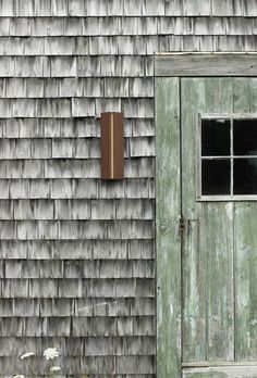 an old wooden door and window in front of a weathered building