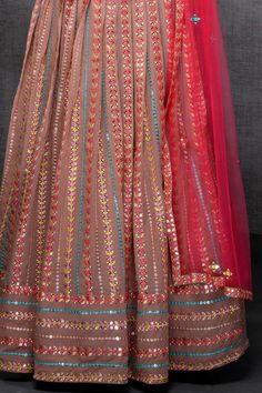 Experience a stunning display of colors with this embroidered georgette lehenga set. The intricate resham thread and mirror work, combined with the viscose fabric, create a truly unique and eye-catching outfit. The added touch of luxurious crepe lining enhances the overall elegance of this attire, making it a perfect choice for festive events, parties, and weddings. Fabric: viscose georgette Work: resham, zari, sequins Blouse Length: 13"-14" Lehenga Length: 42" Sleeve: sleeveless Type: circular Phulkari Pants, Lucknowi Kurta, Gharara Suits, Patiala Salwar Suits, Sequins Blouse, Bridal Dupatta, Georgette Lehenga, Phulkari Dupatta, Chikankari Suits