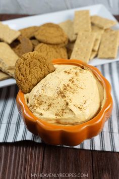 an orange bowl filled with peanut butter and crackers