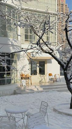 some chairs and tables are covered in snow