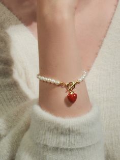 Editor's NotesENGBROX's jewelry is gorgeous and perfect for everyday wear.- Light-weighted- Eye-catching heart pendant detail- Pearl chain band- T-bar closure- Perfect for layering- Minimal and feminine stylesMeasurements(in.)- Size: 5.91in. (L)- Heart: 0.47in.- Toggle: 0.35in. outer diameter- Weight: 0.39oz.Composition & Care- Brass  Epoxy  Freshwater Pearl- Avoid direct heat and moisture- Professional cleaning is recommendedDesigner- by ENGBROX Trendy Valentine's Day Bracelet Jewelry, Adjustable Pearl Bracelet With Heart Beads, Adjustable Heart Beads Pearl Bracelet, Gift Pearl Bracelet With Heart Beads, Elegant Metal Jewelry With Heart Beads, Everyday Red Metal Jewelry, Valentine's Day Pearl Bracelet With Heart Charm, Valentine's Day Heart Charm Pearl Bracelet, Valentine's Day Heart Pearl Bracelet