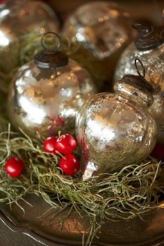 christmas ornaments with red berries in the foreground