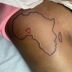 a woman with a tattoo on her thigh that has a heart in the shape of africa