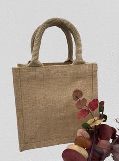 a hand holding a bag with flowers in it