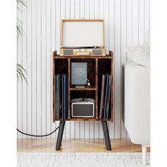 an old record player is sitting on a stand