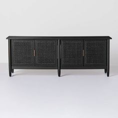 a black sideboard with three doors and two drawers