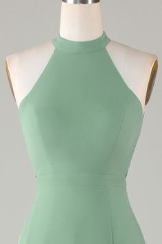 the back of a green dress on a mannequin headdress with an open neckline