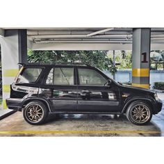 a small black car parked in a garage