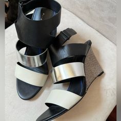 New. Size 38.5 (Us 8). Black, Silver & Ivory. Adjustable Ankle Strap. 3” Heels. Leather Uppers, Footbed & Outsole. New But One Small Scratch On Middle Band. See Last Pic. Silver Wedge Sandals With Heel Strap For Spring, Chic Silver Wedge Sandals With Round Toe, Chic Silver High Heel Wedge Sandals, Chic Silver Sandals With Removable Insole, Silver Open Heel Wedge Sandals For Spring, Silver Leather Wedge Sandals For Party, Elie Tahari, Tri Color, Women's Shoes Sandals