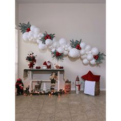 a room decorated for christmas with white balloons and garlands on the wall, teddy bears and other holiday decorations