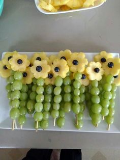 grapes and sunflowers are arranged on skewers