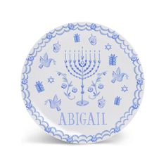 a blue and white plate with an image of a menorah