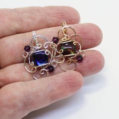 "A glowing, gorgeous hot purple 10mm round paua shell cabochon from New Zealand, with swirls of black and hints of lavender and pink. Set in delicate swirls of sterling silver wire. With two 4mm amethyst-purple Swarovski crystal beads for a bit of glitter. It makes a great gift or stocking stuffer--it's affordable, and who doesn't love purple! This little darling is the perfect size in a sure-to-get-noticed color for wearing every day! It measures about 1-1/4\" long by 3/4\" wide, with a round b Adjustable Iridescent Round Pendant Jewelry, Iridescent Adjustable Jewelry For Gift, Iridescent Cabochon Jewelry For Gifts, Iridescent Cabochon Jewelry Gift, Present Best Friend, Purple Pendant, Pink Set, Paua Shell, Swarovski Crystal Beads