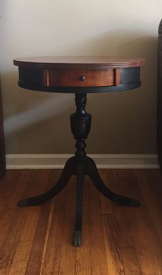 a wooden table sitting on top of a hard wood floor