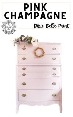 a pink dresser with flowers on top and the words pink champagne written in black above it