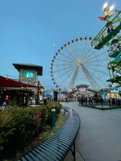 an amusement park with a ferris wheel in the background