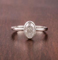 a diamond ring sitting on top of a wooden table