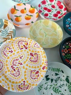 colorful plates with designs on them sitting on a table