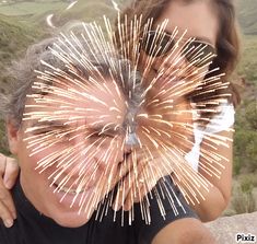 two people with their faces covered by fireworks