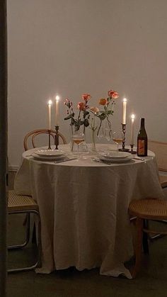 the table is set with candles and plates