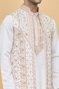 Cream longline Nehru jacket with contrasting floral jaal pattern aari tilla embroidery. Comes with embroidered placket and bordered kurta and a pant. - Aza Fashions Chanderi Bandhgala With Intricate Embroidery, Designer Embroidered Nehru Jacket In Jamawar, Designer Embroidered Nehru Jacket, Transitional Straight Kurta Bandhgala With Intricate Embroidery, Elegant Nehru Jacket With Chikankari Embroidery, Eid Nehru Jacket With Dabka Work, Transitional Bandhgala With Chikankari Embroidery, Transitional Straight Bandhgala With Intricate Embroidery, Festive Nehru Jacket With Dabka Work In Chanderi