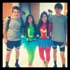 three young people dressed in costumes posing for a photo