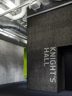 the entrance to knight's hall is shown in black granite with white lettering on it