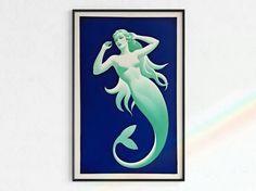 there is a blue and white painting with a mermaid on it's back side