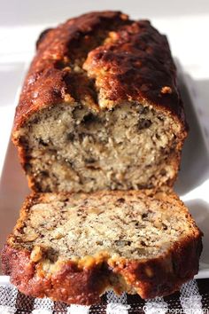 a loaf of banana bread sitting on top of a white plate