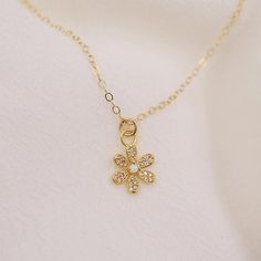 The sweetest daisy charm hangs along a delicate gold chain. It's petals are adorned with tiny cz's and a center opal stone. DETAILS: 14kt gold filled chain opal and cz accents choose length model wearing 17 inches long Delicate 14k Gold Filled Tarnish Resistant Charm Necklaces, Delicate 14k Gold-filled Tarnish-resistant Charm Necklaces, Gold Dainty Opal Charm Necklace, Dainty Gold Opal Charm Necklace, Delicate 14k Gold-filled Charm Necklace, Tarnish Resistant, Dainty Tiny Charm Necklaces Gold Plated, Dainty Flower Charm Necklaces, Dainty 14k Gold Filled Charm Necklaces, Dainty 14k Gold-filled Flower Charm Necklaces