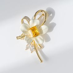 Elevate your outfit with this stunning Copper Yellow Diamond Flower Brooch. Adorned with intricately cut yellow diamonds, this brooch adds a touch of elegance to any ensemble. The perfect accessory for a special occasion or to elevate your everyday look.      Tarnish proof    Water proof    Sleep / Nap proof    Safe for sensitive skin    Wear it while working out &showering    Designed to wear 24/7    If there is no stock, the product will take   60    days to produce    Please leave your usual Diamond Flower Brooch, Sun And Moon Rings, Yellow Diamonds, Moss Agate Ring, Flat Back Earrings, Feather Necklaces, Gold Bracelet Chain, Diamond Flower, Blue Zircon