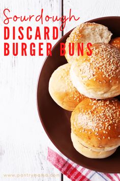 three sesame seed bagels on a plate with the words sourdough biscuit burgers