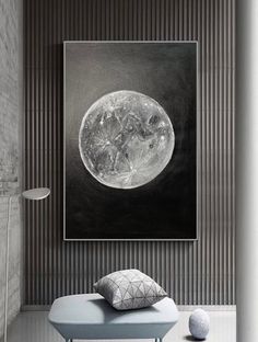 a black and white photo hanging on the wall next to a blue bench in a room