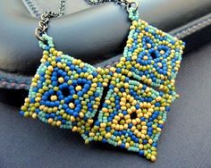 a blue and yellow beaded necklace sitting on top of a car seat