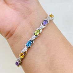 PRODUCT INFO :                   Stone : Natural Blue Topaz / Peridot / Amethyst / Citrine Stone size : 4x6MM oval Accent Stone : Cubic Zircon Metal type : Sterling silver (92.5) Approximate weight :  13 grams ADDITIONAL INFO : ~ Every product consist of 925 stamp. ~ If you want same product in different Stone / Plating ( gold and rose gold) / different Metal (14 k - 18 k gold ) , feel free to contact me .  ~ If you are in rush and want your pretty jewelry pieces early , we can sent it to express service with extra shipping cost of 15 -20 $ ~ Since we use natural gemstones, the stone may vary slightly in Color, Hue and Reflection. ~ Since all pictures are taken from close it may appear big , read product dimension carefully. ~ We can supply jewelry in bulk , For Wholesale Quantity and Disc Multi-stone Round Diamond Bracelet For Anniversary, Cubic Zirconia Bracelets With Gemstone Accents Gift, Diamond Bracelets With Gemstone Accents For Anniversary, Fine Jewelry Bracelets With Gemstone Accents And Cubic Zirconia, Silver Multi-stone Diamond Bracelet, Cubic Zirconia Crystal Gemstone Bracelet, Diamond Bracelets With Gemstone Accents, Fine Jewelry Silver Diamond Bracelet With Multi-stones, Anniversary Multi-stone Cubic Zirconia Tennis Bracelet