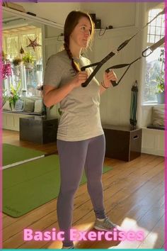 a woman standing on a yoga mat holding a pair of scissors