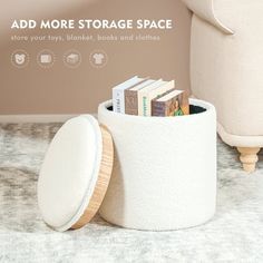 there is a white storage container with books in it on the floor next to a chair