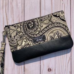 PAISLEY LEATHER WRISTLET Black and cream paisley leather | Etsy Cork Clutch, Cork Purse, Zipper Pencil Case, Black Leather Clutch, Paisley Fabric, Purse For Women, Zipped Bag, Genuine Leather Bags, Black And Cream