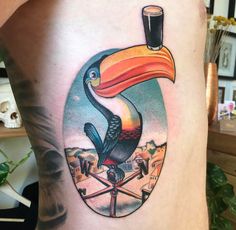 a tattoo with a toucan sitting on top of it