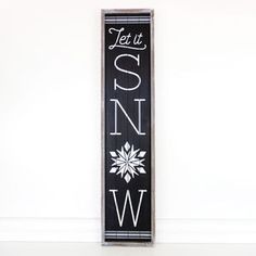 a black and white sign that says let it snow