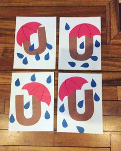 four pieces of paper cut out to look like the letter u with umbrellas on them