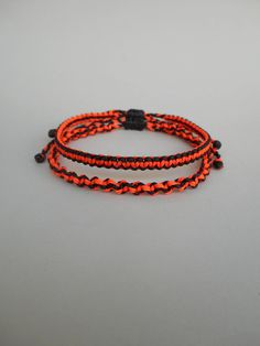 Black and neon orange macrame bracelets. Handmade of waxed polyester cord. Style options to choose: - the flat braided style, - the twisted braided style - or save on shipping and grab the set of 2 in which both styles are included. The flat braided style is also reversible and can be worn on both sides! The design is unisex suitable for all ages! This is an unique idea for a special gift for someone or a treat for yourself ;) Casual Orange Braided Bracelets For Friendship, Casual Orange Braided Bracelet For Friendship, Adjustable Orange Braided Bracelet With Sliding Knot, Orange Braided Bracelet With Sliding Knot As Gift, Two Color Bracelet, Orange Macrame, Wax Cord Bracelet, Surfer Bracelets, Color Bracelet