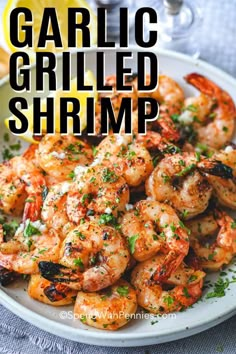 garlic grilled shrimp on a plate with lemon wedges and parsley garnish