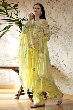 Lemon flared long kurta with floral motif print and lace finish neckline. Paired with pants and chiffon dupatta.
Component: 3
Block Print, Embroidered
Neckline: V Neck
Sleeve Length: Long
Fabric: Cotton Cambric; Dupatta: Chiffon
Color: Yellow, Green
Gathered flare - Aza Fashions Green Anarkali, Floral Block Print, Kurta Set For Women, Embroidered Neckline, Indian Fashion Designers, Stylish Dress Designs, Kurta Set, Floral Chiffon