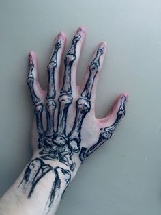 a person's hand with black and white ink on it, holding out their hands