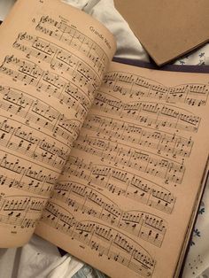 an open book with sheet music on it