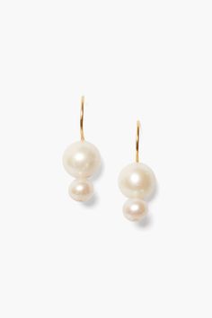 A modern take on the classic pearl, these 18k gold plated sterling silver drop earrings feature two graduated white freshwater pearls on a French hook. A timeless design perfect on its own. 18k gold plated sterling silver. 1" drop. Handmade in Vietnam. Balloon Earrings, Unique Handmade Earrings, Gold Wrap, Bridal Hair Jewelry, Sterling Silver Drop Earrings, Freshwater Pearls Earrings, Ruby Jewelry, White Freshwater Pearl, Pearl Set